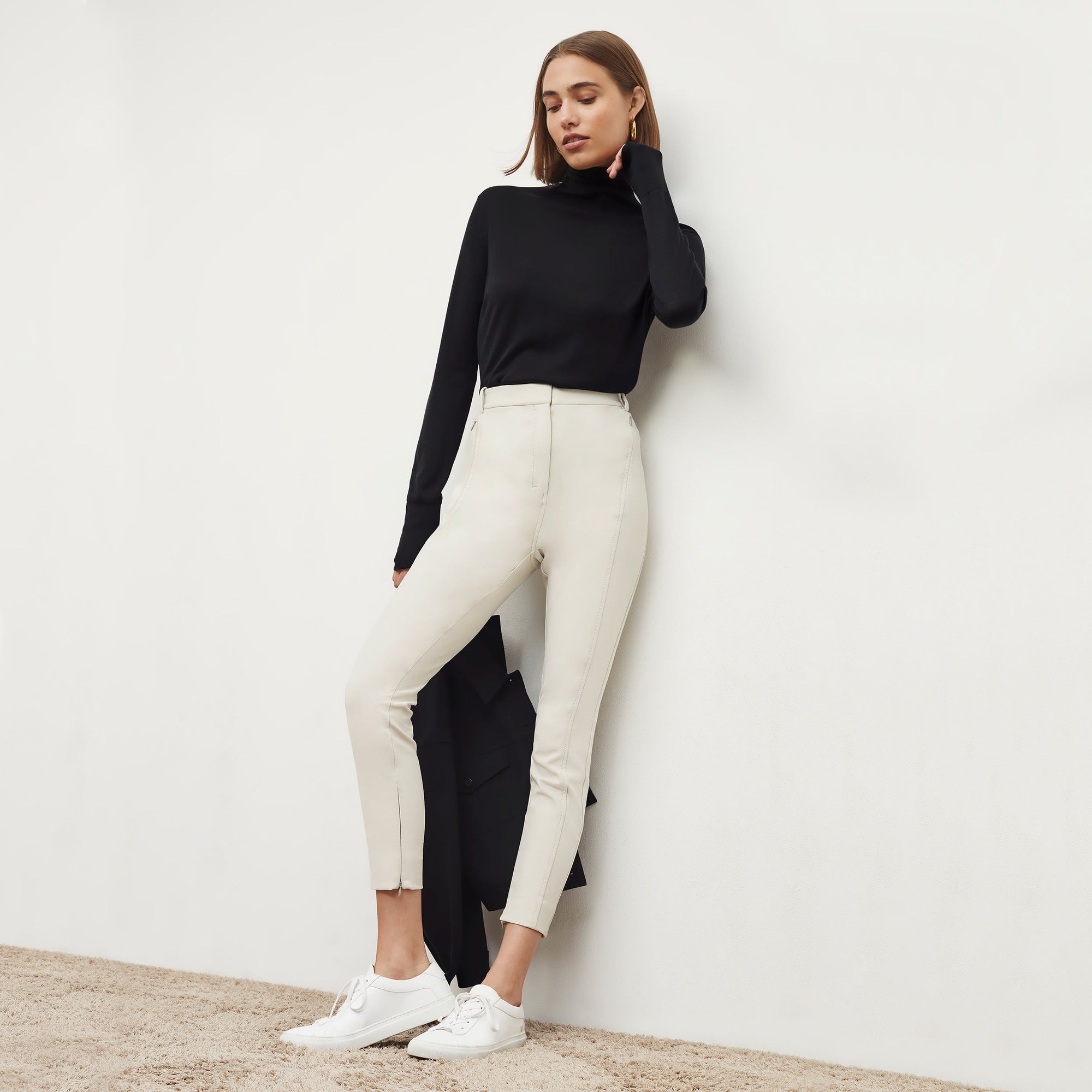 Front image of a woman standing wearing the Curie Pant—Everstretch in Bone | Exclude