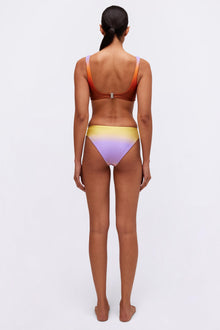 Bikini bottom with gradient color transition from yellow to purple and white trim, shown from back view.