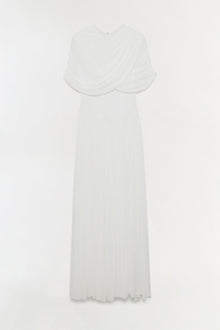 White jersey maxi dress with draped cape overlay and pleated skirt.