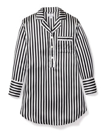The Womens Silk Nightshirt in Black and White Bengal Stripe by Petite Plume, from the Cabaret Collection, features luxurious Mulberry silk, a collar, partial button placket, chest pocket, and cuffed sleeves. Laid flat on white background.
