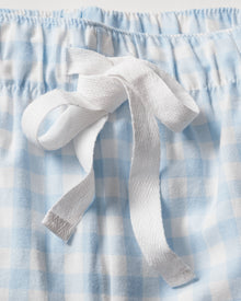 Close-up of a light blue and white gingham twill fabric with a white bow-tied drawstring on an elastic waistband, part of the Mens Twill Pajama Short Set in Light Blue Gingham by Petite Plume.