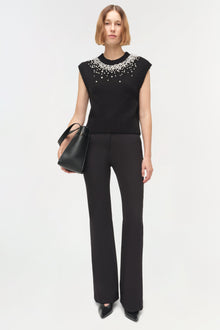 Black sleeveless knit vest with pearl beading across neckline and shoulders.
