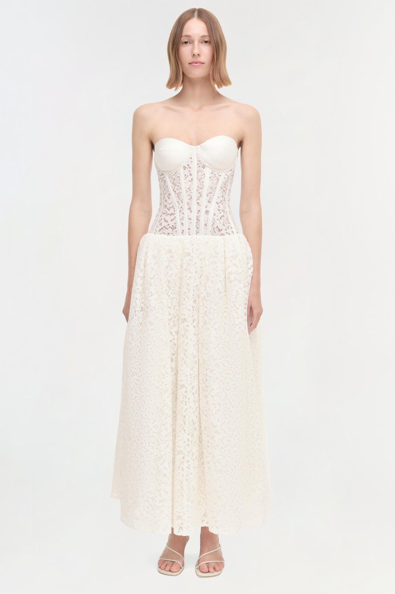 Ivory lace strapless dress with sweetheart neckline, corset bodice, and ankle-length skirt.