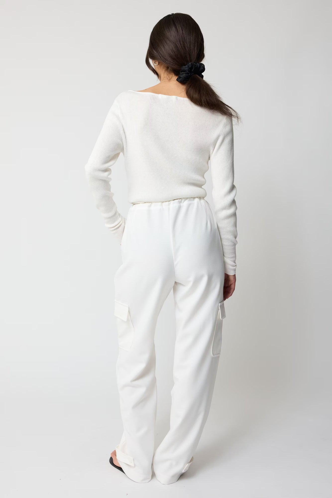 Person wearing a white outfit on a plain background