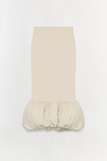 Cream-colored midi skirt with fitted body and voluminous gathered hem detail at the bottom.