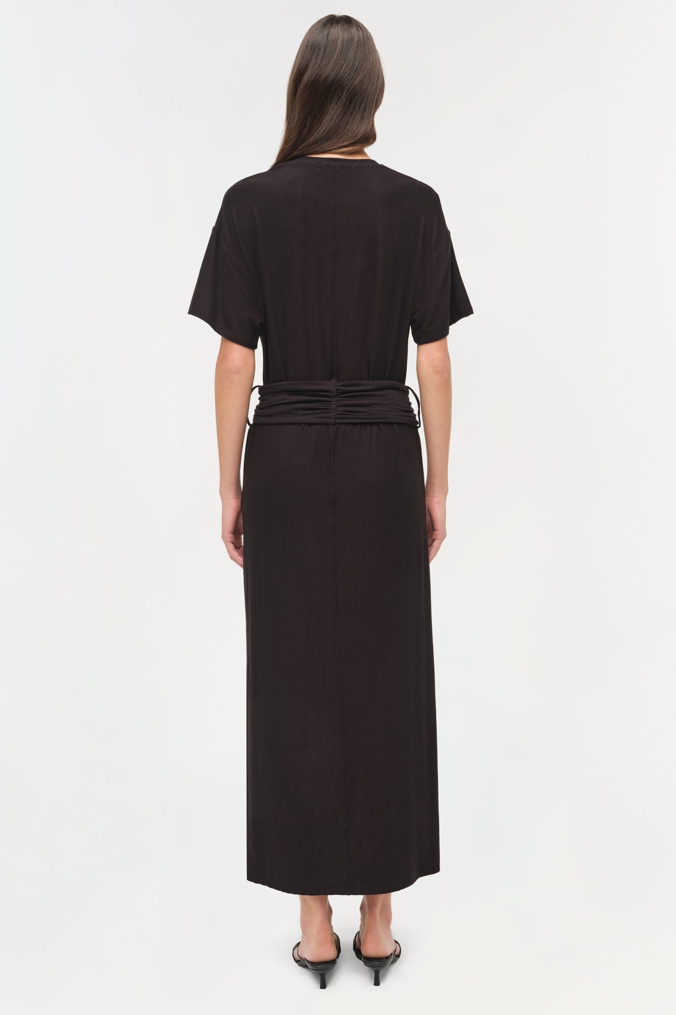 Black jersey t-shirt dress with short sleeves and ruched waist detail, shown from back view.