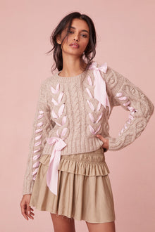 Sweater with chunky Peruvian cable detailing and a charmeuse ribbon threaded throughout.