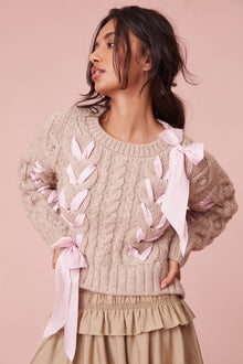 Sweater with chunky Peruvian cable detailing and a charmeuse ribbon threaded throughout.