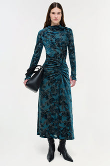 Teal velvet midi dress with black floral print, long sleeves, and ruched side detail.