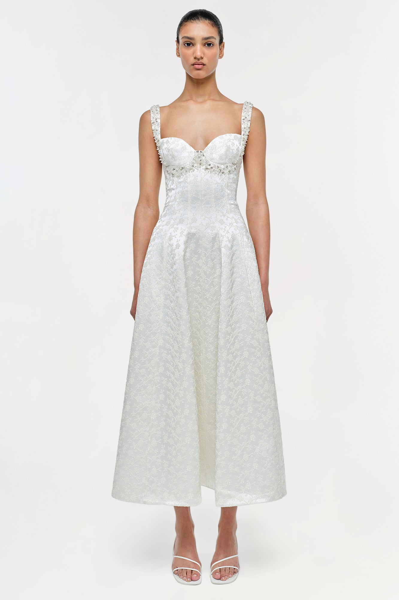 White jacquard midi dress with sweetheart neckline, beaded straps, and fitted bodice on model.