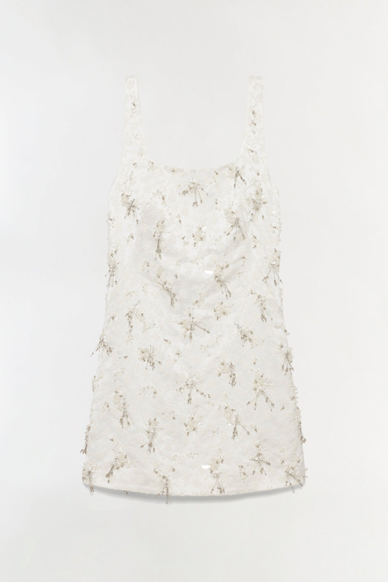 White mini dress with square neckline and beaded tassel embellishments throughout.