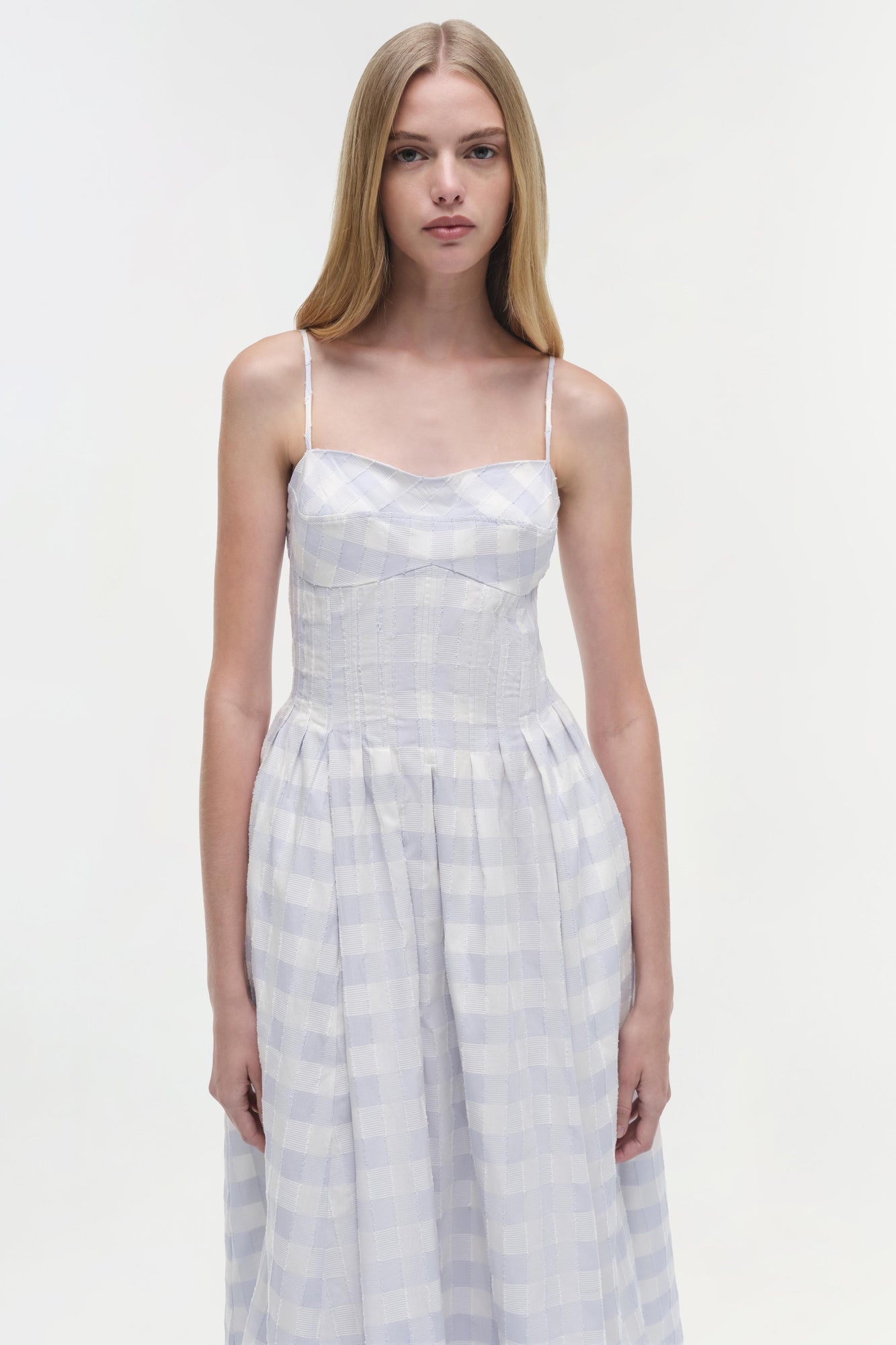White and lavender gingham cotton midi dress with thin straps and pleated skirt.