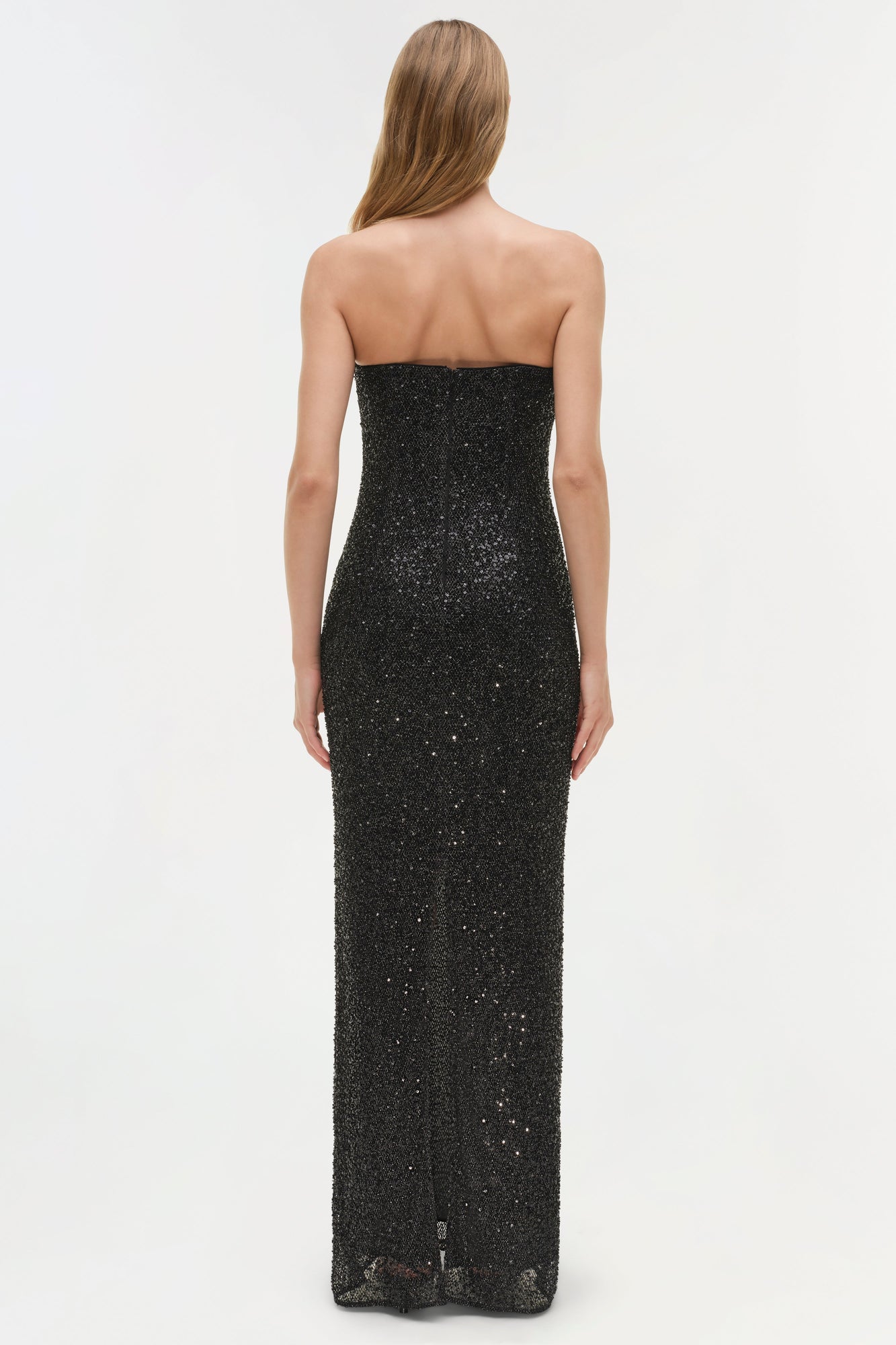 Black sequined strapless gown with floor-length fitted silhouette, shown from back view.