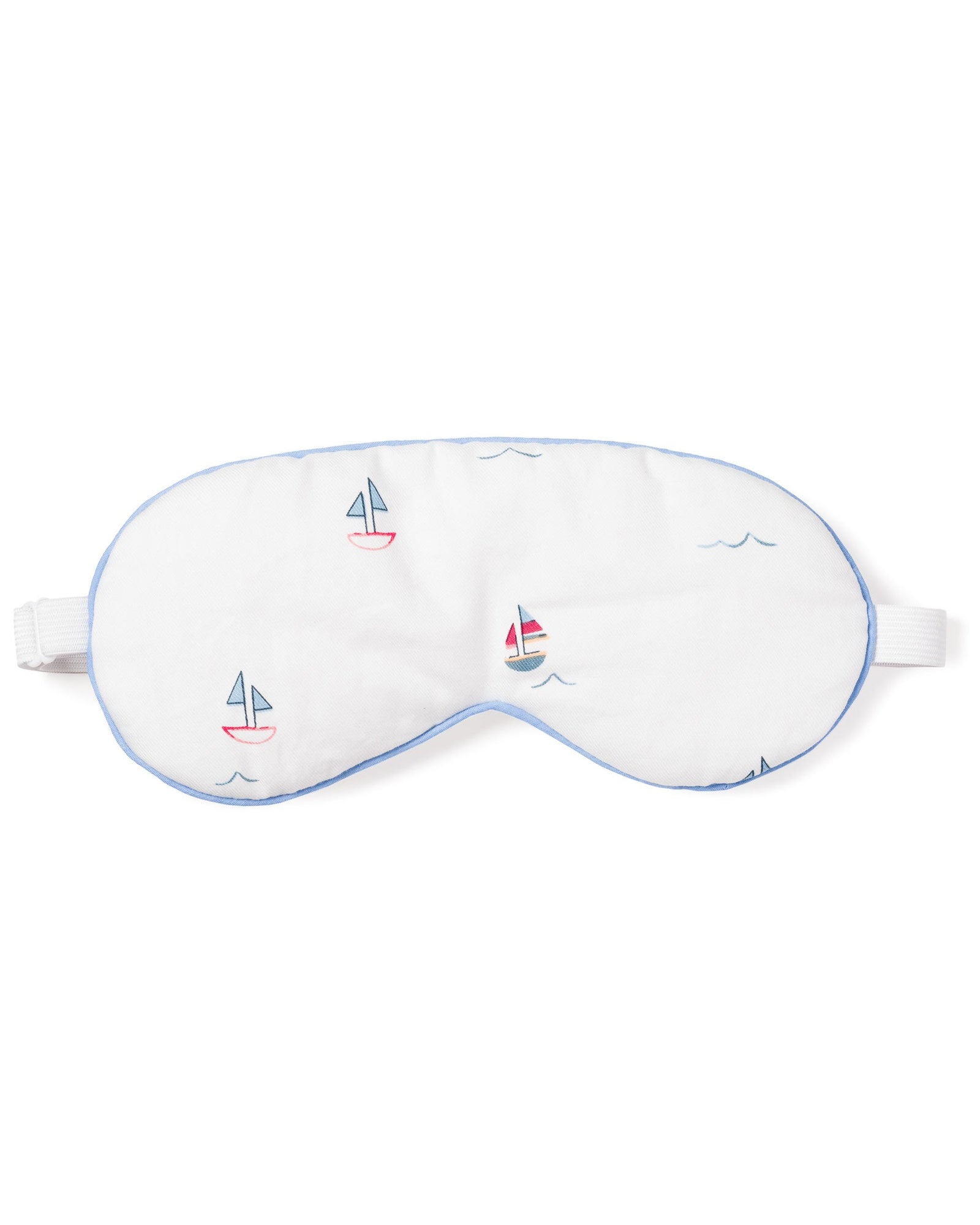 The Adults Twill Sleep Mask in Bateau by Petite Plume is a white mask with light blue trim and colorful sailboat designs. It has an adjustable strap for a luxurious sleep experience and makes a perfect monogrammed gift for those who appreciate elegance at bedtime.