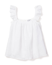 The Womens Gauze Celeste Top in White by Petite Plume is a refined wardrobe staple. Crafted from luxury gauze, it features ruffled straps and a textured appearance, with a small tag near the neckline for added elegance. Set against a plain white background, it enhances its feminine silhouette.