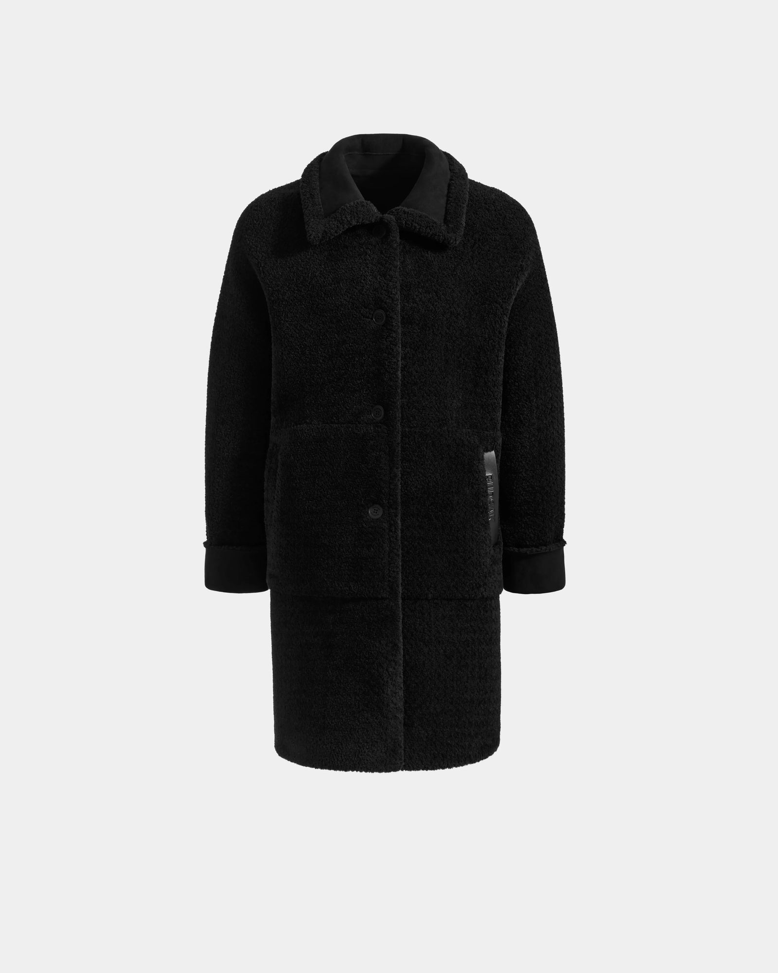 The ANGILICA - L125600 Black by Rudsak is a luxe black faux shearling coat with a classic collar, large buttons, two front pockets, and turned-up cuffs—crafted from premium faux suede and shown against a plain light background.