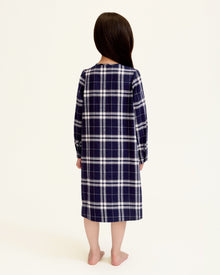 The Girl's Brushed Twill Beatrice Nightgown in Oxford Tartan features a navy, white, and gray plaid pattern, long sleeves, a round neckline, front buttons, and pleats near the chest.