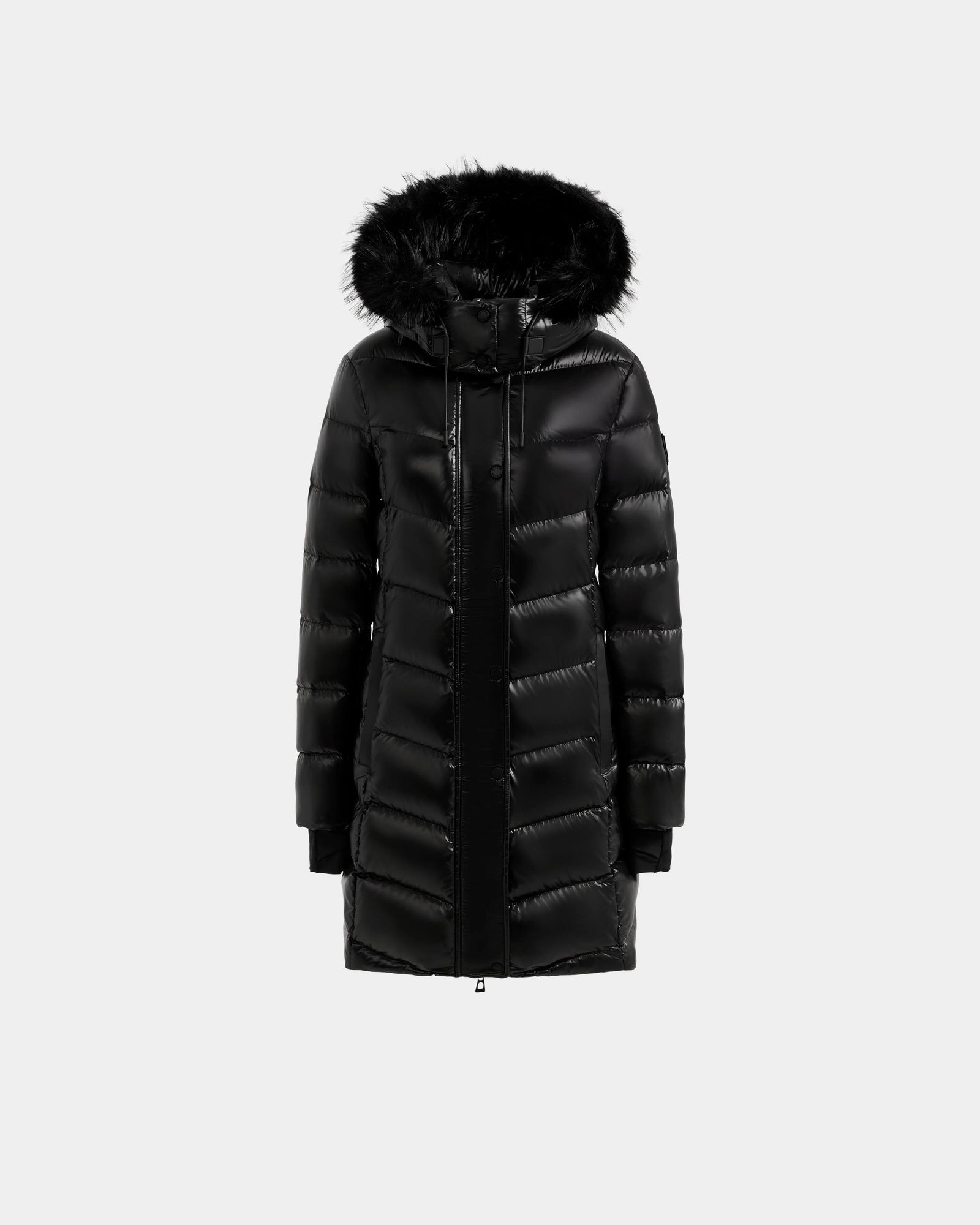 The ELISA S - L125572 Black by Rudsak is a long black quilted puffer jacket with a shiny finish, front zipper, horizontal quilting, ribbed cuffs, and a black faux fur-trimmed hood, shown on a plain light gray background.
