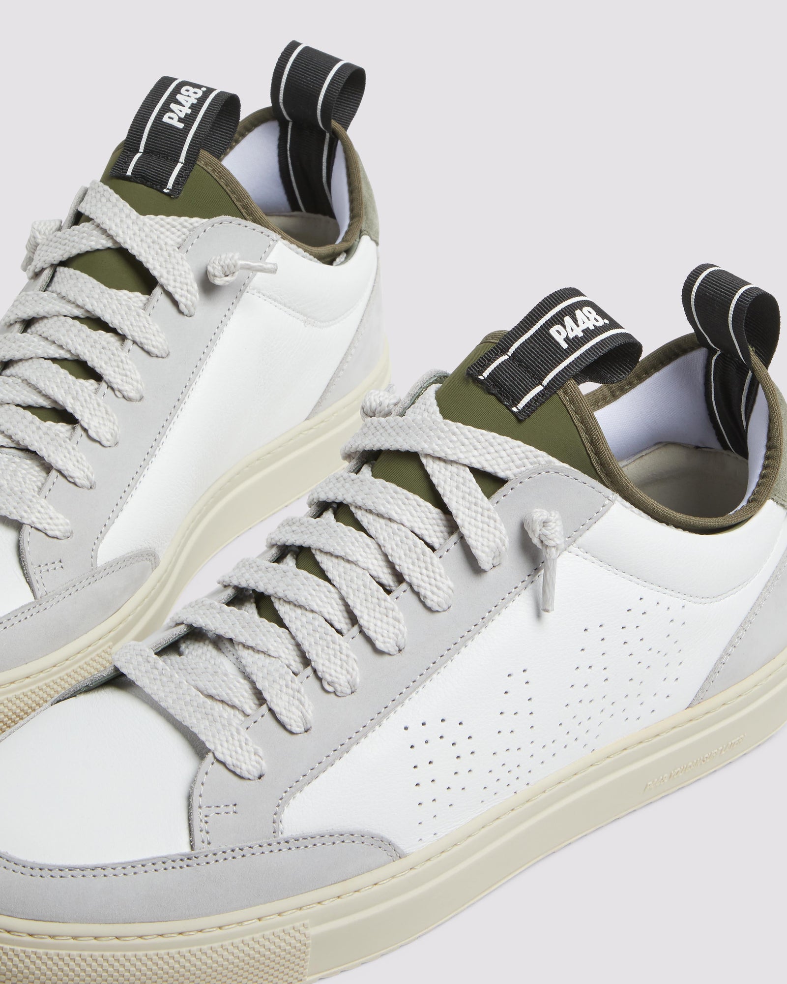 Side angle of white, grey and green sneakers