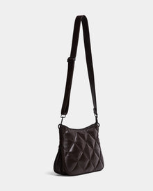 The Rudsak ALICIA - 8323507 Espresso is a womens dark brown quilted purse with an adjustable strap, soft padded texture, and a rectangular shape with gently rounded edges, shown against a plain light gray background.