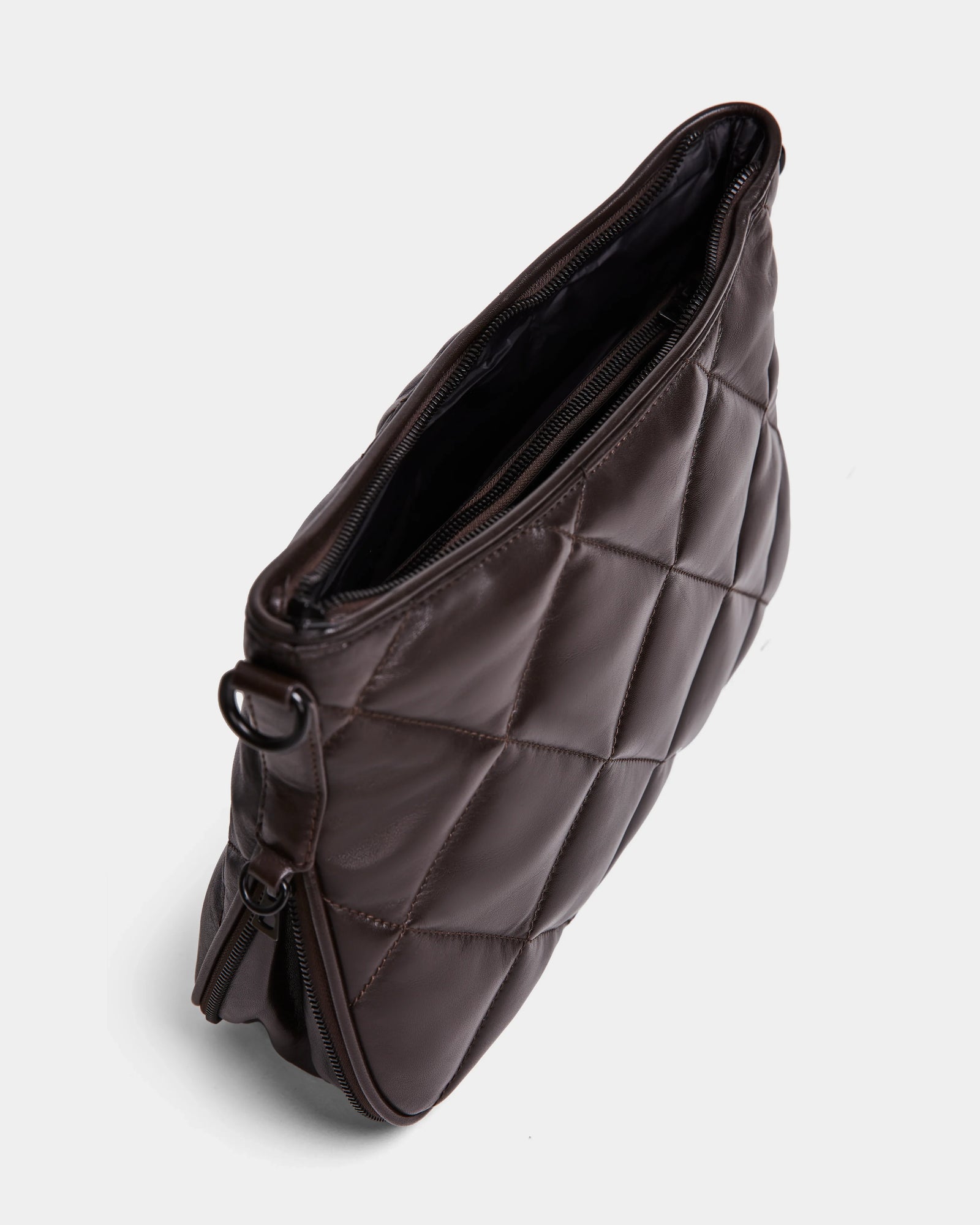 A top-down view of the Rudsak ALICIA - 8323507 Espresso, a luxe, dark brown quilted leather purse with zipper opening and metal side rings, photographed on a white background.
