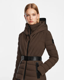 A woman in the Rudsak ALISA - L124506 Espresso coat, featuring an elegant vegan leather belt.