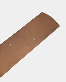 A close-up of the Rudsak ALLEA - 8424506 Antique Bronze womens leather waist belt with multiple small holes, displayed on a light gray background.