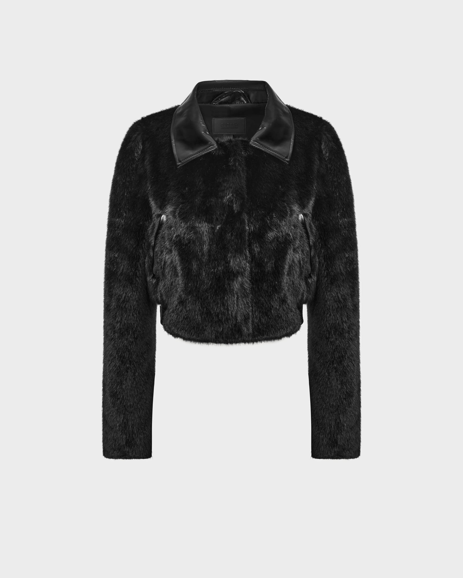 The EVELYN - 8124791 Black by Rudsak is a black faux fur cropped jacket with long sleeves, a front zipper, and a shiny black collar—an eye-catching luxury outerwear piece shown on a plain white background.