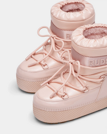 Close-up of HARLOW Y - 1223500 Pastel Pink high-top sneakers with thick soles, elastic ankle cuffs, and decorative laces. These stylish Rudsak winter boots for kids keep feet cozy. Plain white background.