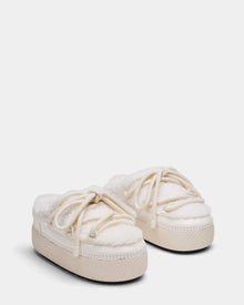 The Rudsak HARRIET - 8224519 Iceland slippers are off-white womens slip-ons with thick rubber soles, soft faux shearling lining, and decorative laces, styled like cozy fur-lined boat shoes.