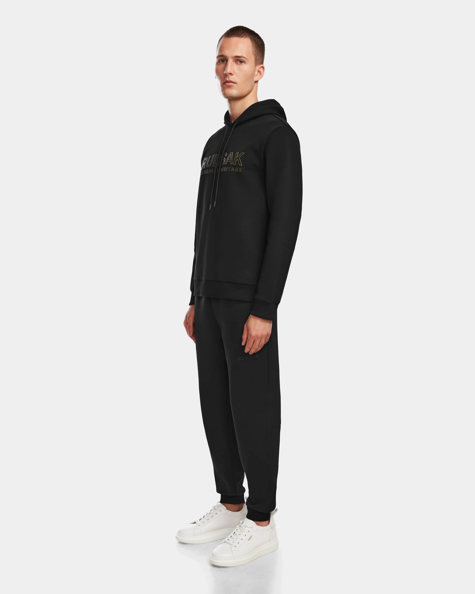 A man in a black Rudsak JARED - 6524533 hoodie and sweatpants.