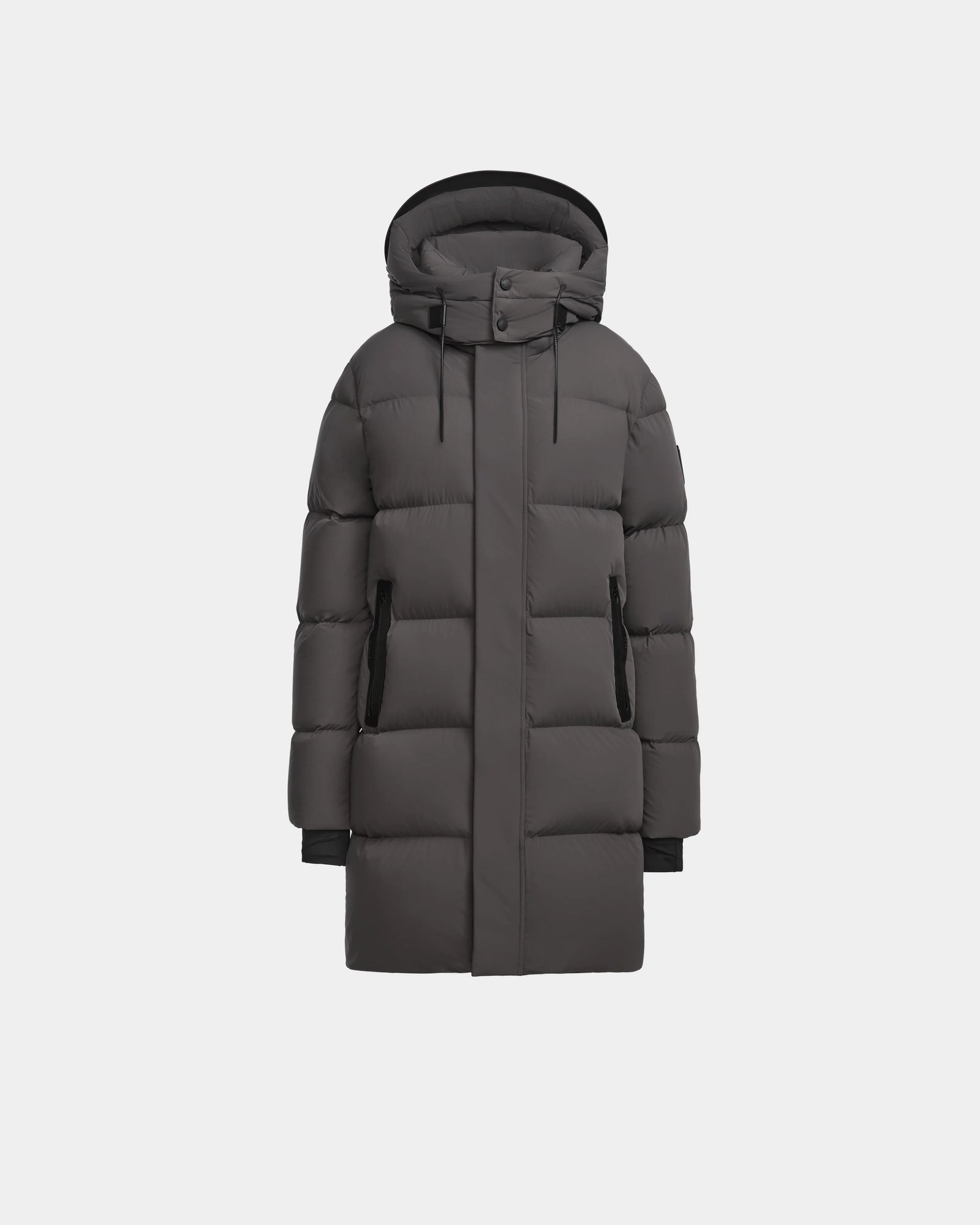 The Rudsak JOELLE - 8124729 Grey is a long, dark grey womens quilted down coat with a hood, front zipper, and snap buttons, made with RDS-certified down, shown against a plain white background.