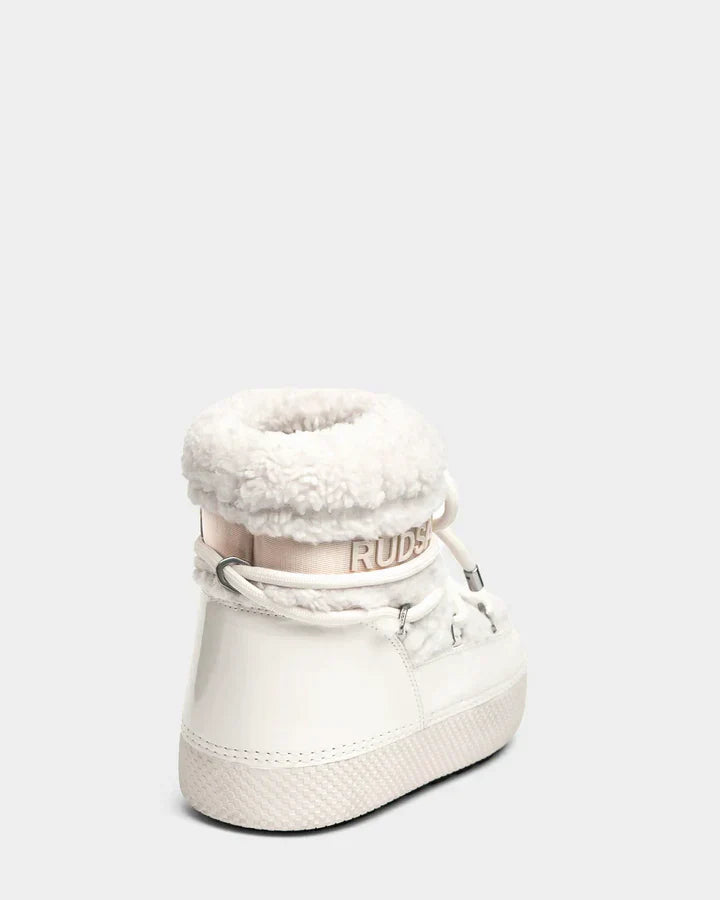 The KATHY - 8223513 Iceland by Rudsak is a white high-top sneaker for women, featuring a fluffy faux shearling-lined collar and laces. The branding appears on a pale strip above the heel, shown against a light gray background.