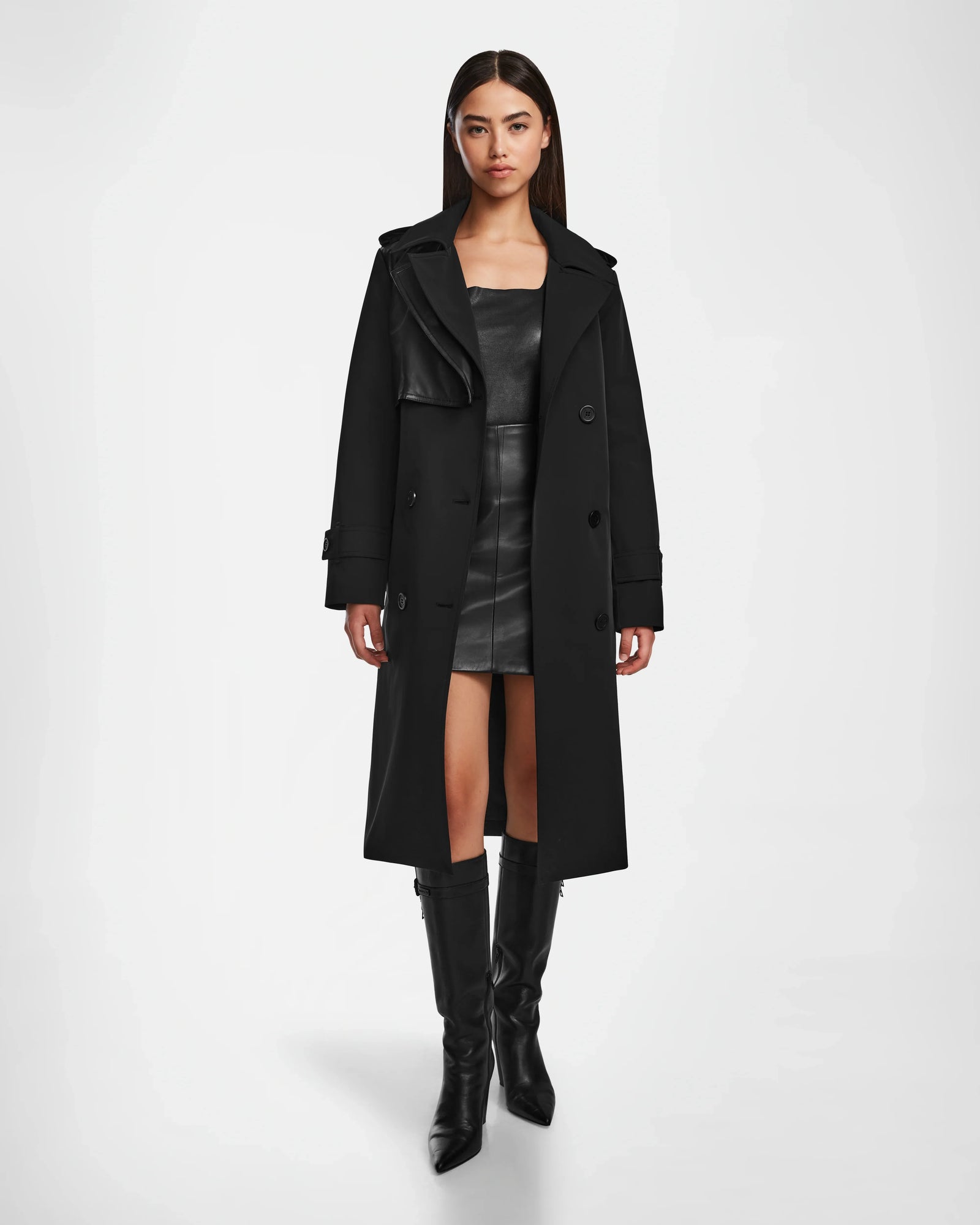 A woman wearing the KINDA - 8124690 Black trench coat by Rudsak featuring subtle leather detailing.