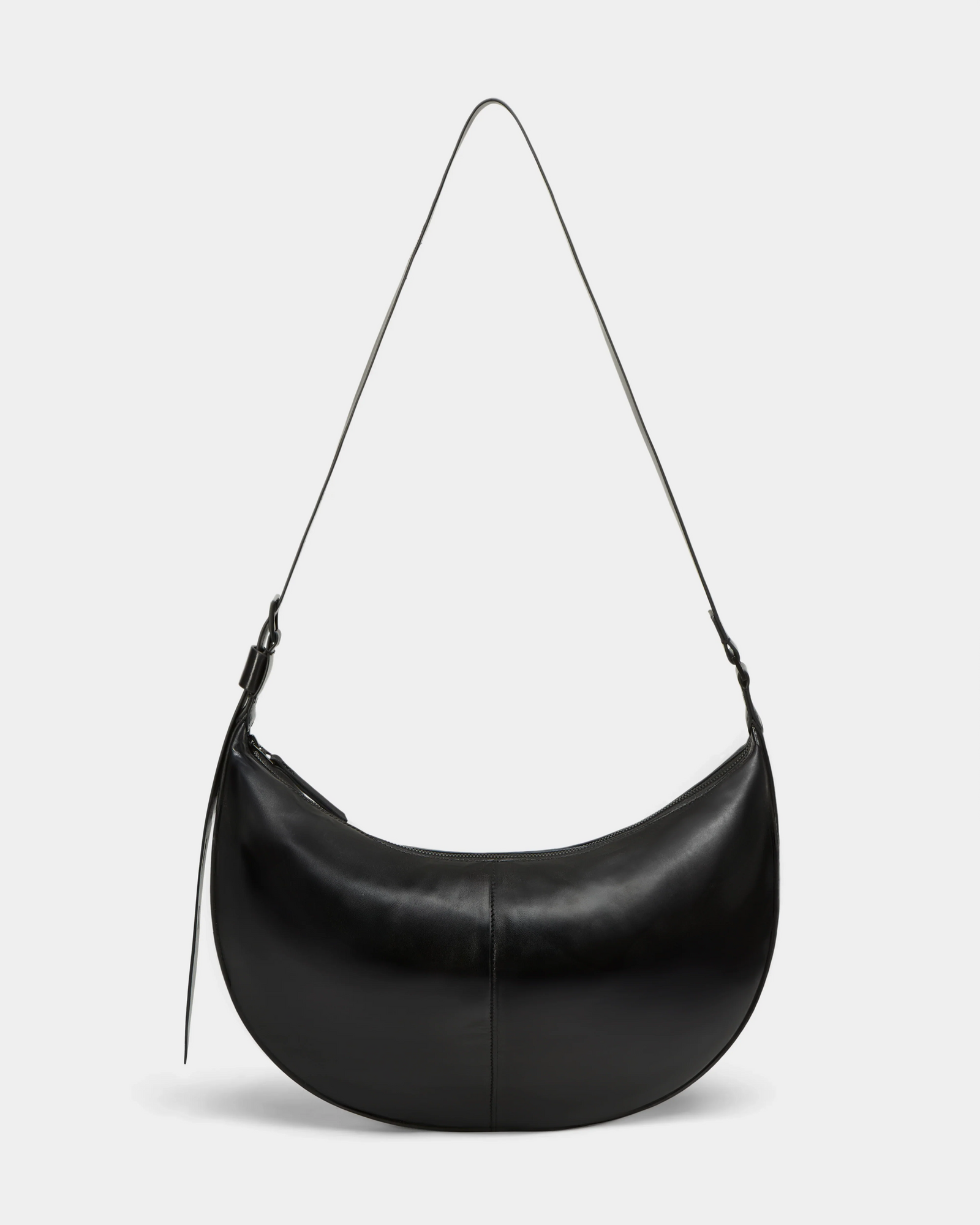 The LANISSA - 8324505 Black by Rudsak is a crescent-shaped black leather hobo bag with a single strap and zipper closure, shown against a plain light gray background.