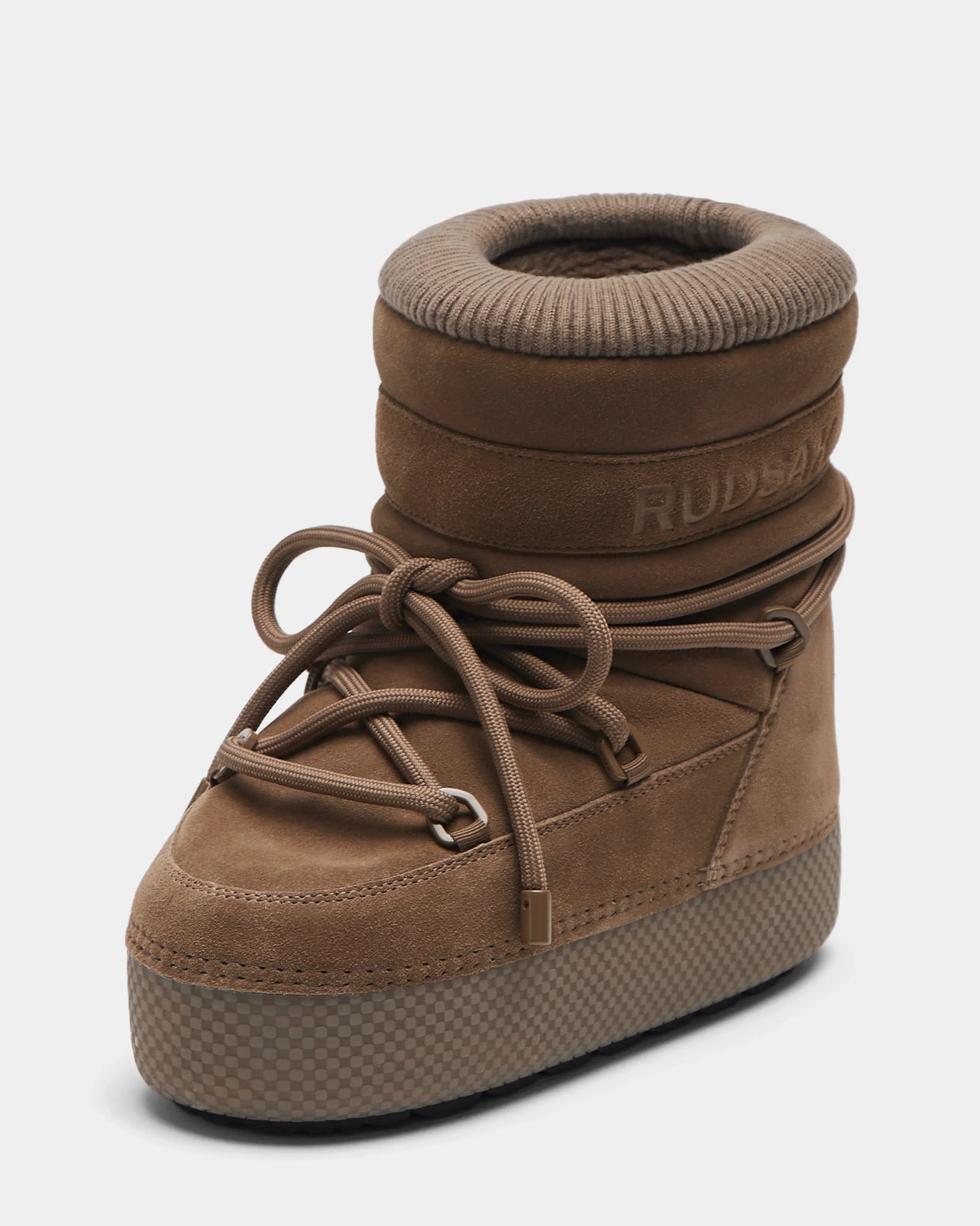 The Rudsak MACE S - 8224543 Camel is a single brown, high-top winter boot with thick padded ankle, large front laces, a textured platform sole, water-repellent suede finish, and RUDSAK branding on the side.