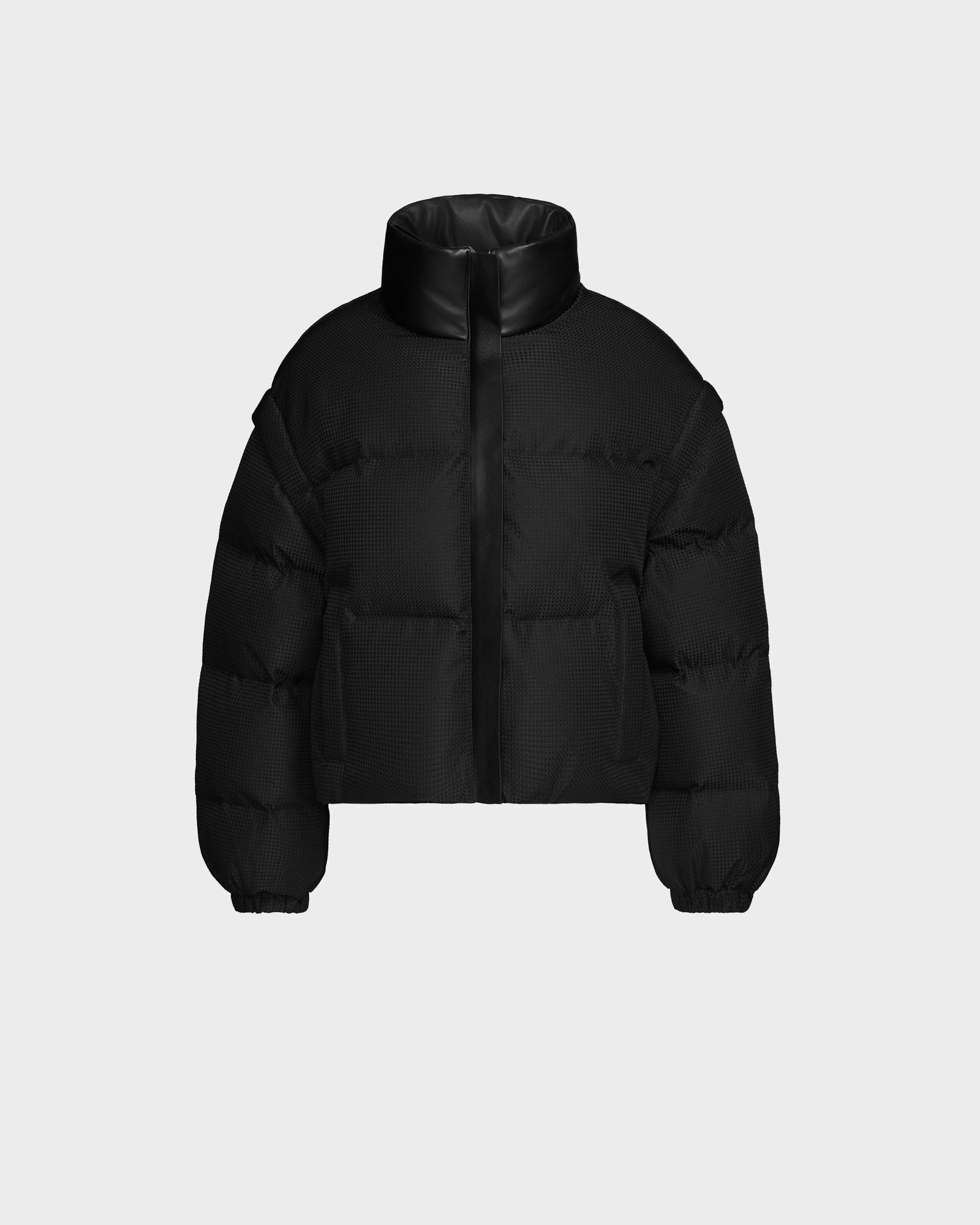 The Rudsak OPRAH - 8124708 Black is a women’s cropped down puffer jacket with a high collar, front zipper, side pockets, and elastic cuffs. Made from ethical down, it’s displayed on a plain light gray background.