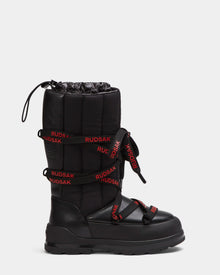 The RODIN - 8224502 Black by Rudsak is a women’s mid-calf winter boot featuring a thick padded shaft, polar fleece lining, black anti-slip sole, red laces with RUDSAK, and a drawstring closure for warmth and stability.