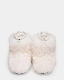 The ROSSY - 8224518 Iceland slippers by Rudsak are fluffy white with a soft, shaggy Mongolian fur-like texture, satin-like ankle trim, and feature a small decorative loop and bead on each slipper against a plain light background.