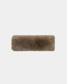 The SANDIE - 8423507 Cement by Rudsak is a rectangular, fluffy brown faux fur headband with a soft texture, shown on a plain white background—ideal as a cozy women’s winter accessory.