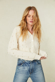 weater features pearl and crystal embellishments all over the front and the long blouson sleeves 