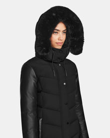 A woman wearing the Rudsak ELSA - L123535 Black quilted down puffer.
