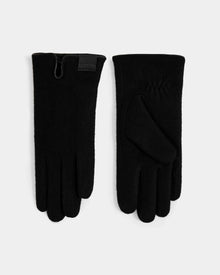 A pair of OLGA - L425541 Black women’s wool gloves by Rudsak is shown on a light surface, one displaying the palm and the other the back with a branded wrist label—an elegant cold-weather accessory.