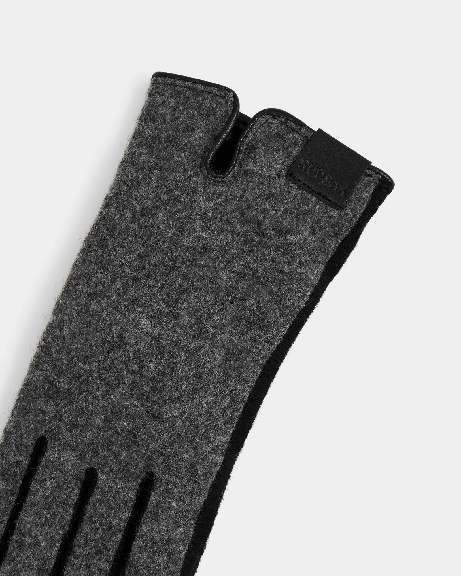 A close-up of the Rudsak OLGA - L425541 Grey women’s wool glove, featuring black detailing and a leather label by the wrist—an essential for style and warmth, shown against a plain light background.