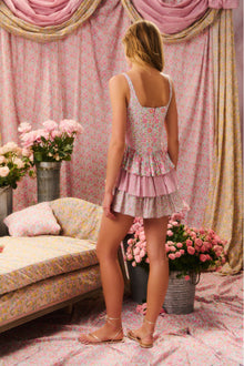 Two-toned mini dress featuring a fitted bustier-inspired corset top that descends to a three-tiered ruffle skirt.