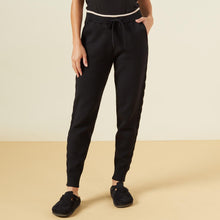 Front view of model wearing the supersoft sweater knit color block sweats in black.