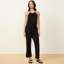 Front view of model wearing the supersoft halter jumpsuit in black.