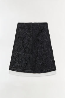 Black jacquard midi skirt with floral pattern and white underskirt, A-line silhouette.