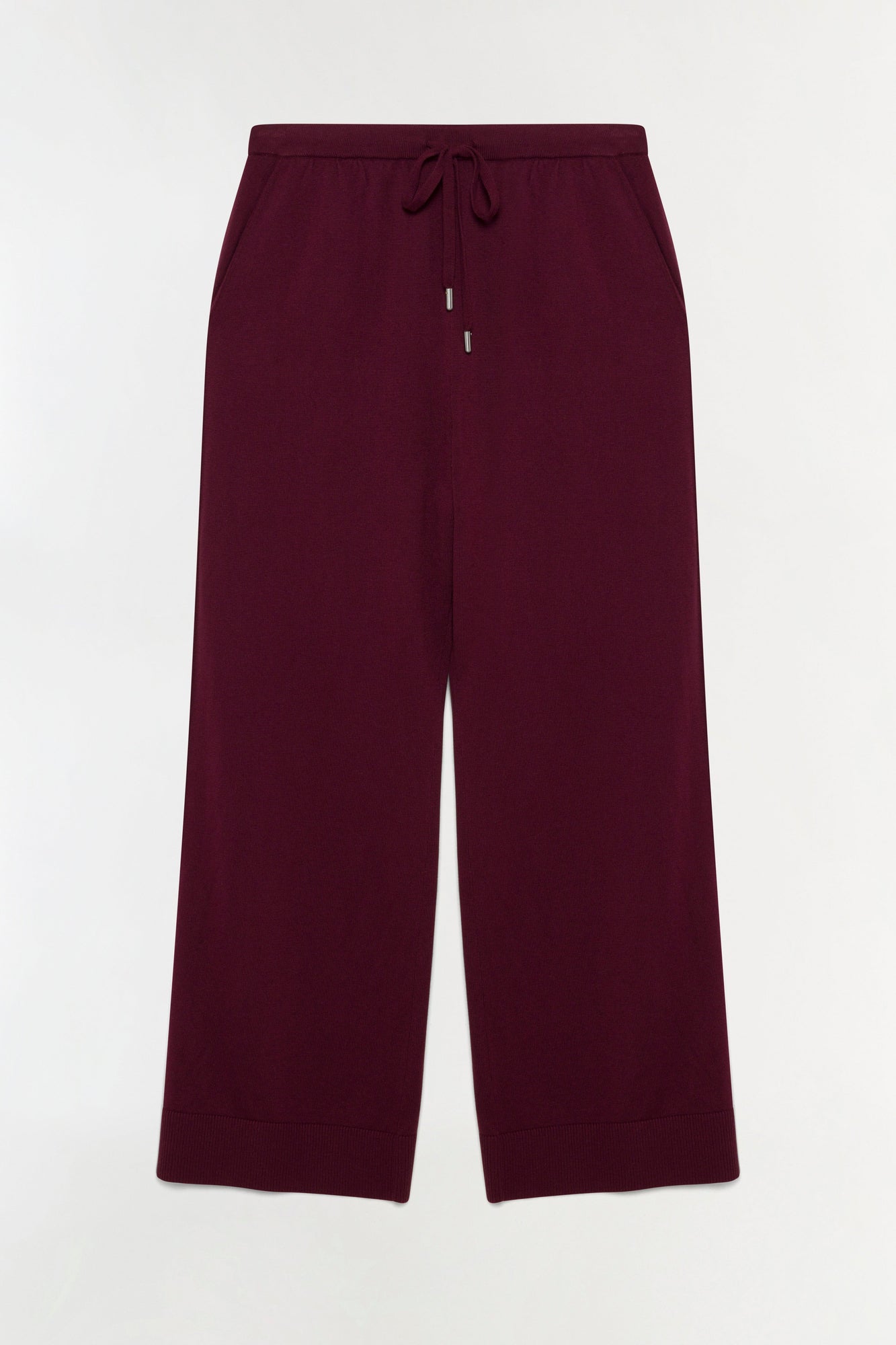 Deep burgundy knit pants with drawstring waist and ribbed cuffs.