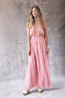 Model wearing pink floral halter maxi dress